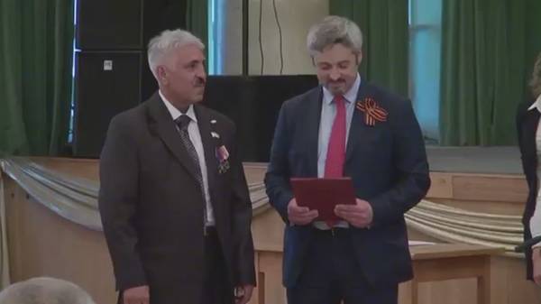 Начальник управления президента Павел Зенькович (справа) награждает Хостая Мубарака Шаха