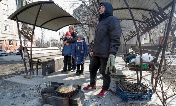 Люди готують їжу у дворі в обложеному південному порту Маріуполя, Україна, 23 березня 2022 року. Фото: Олександр Єрмоченко / Reuters
